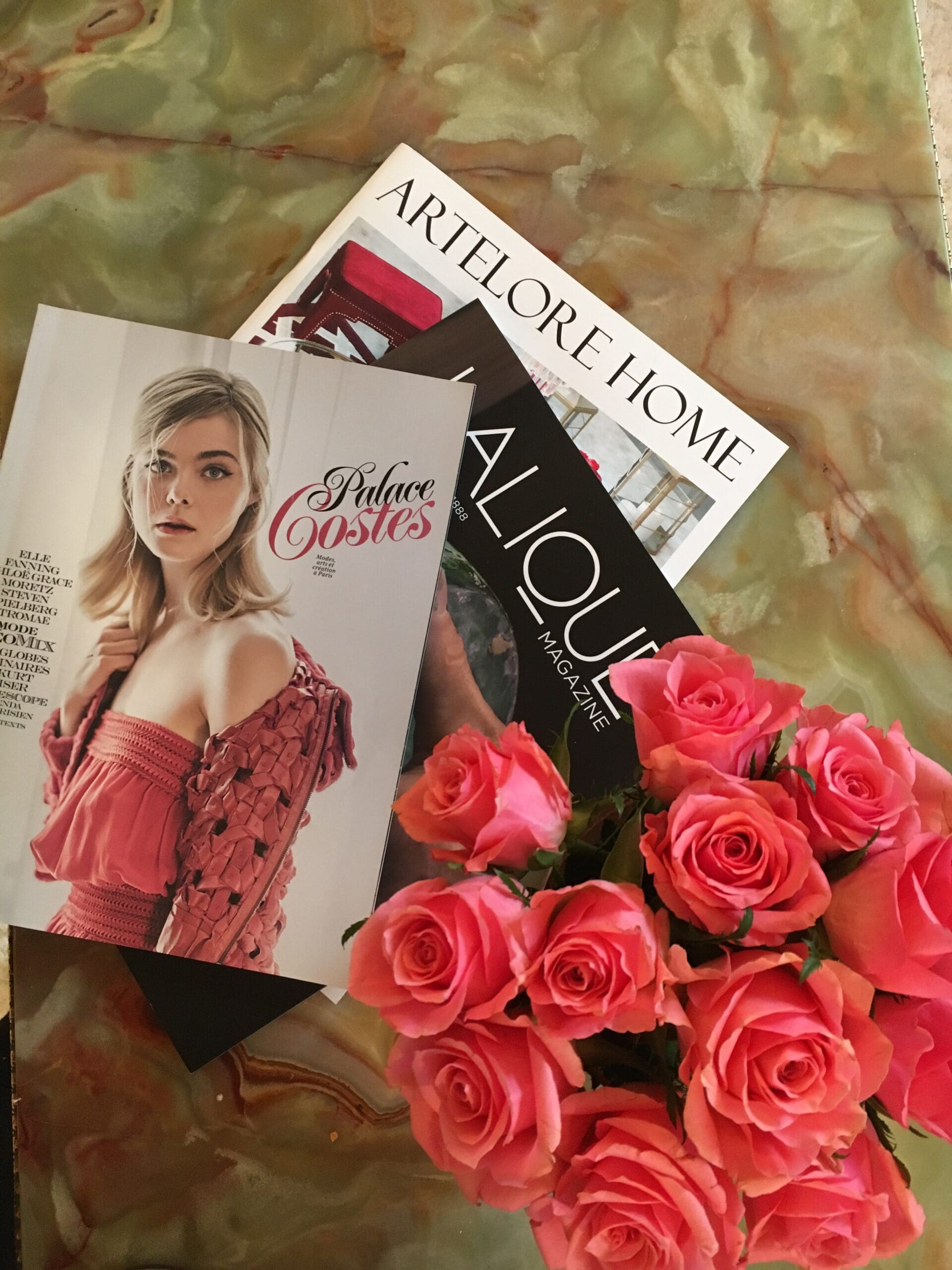 Stylized flat lay of magazines and roses